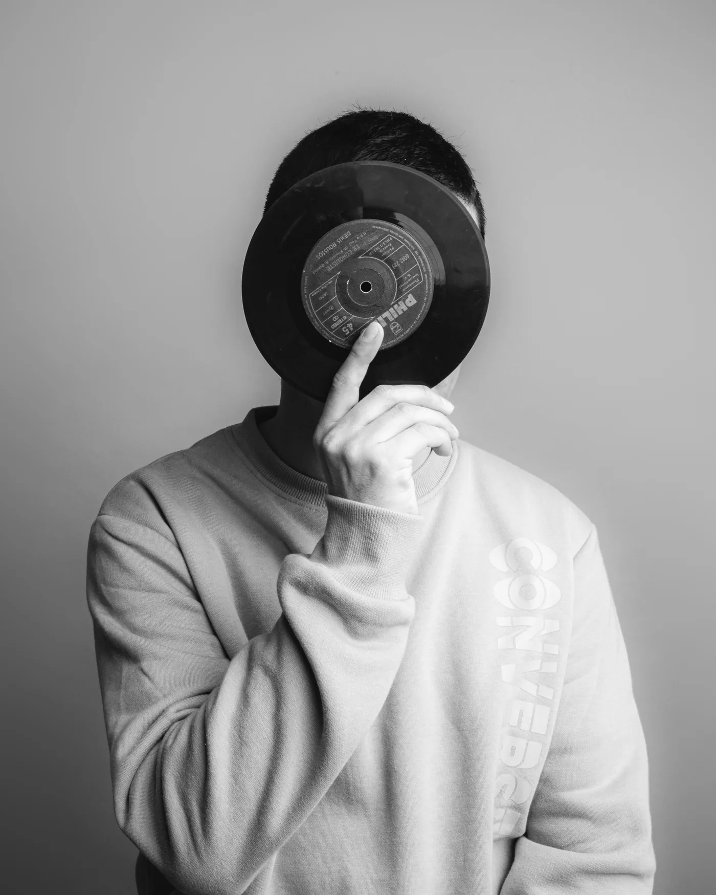 DJ de SeipiesMusic cubriendo el rostro con un disco de vinilo, sesión de fotos artística